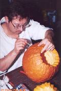 Dave intently carving his pumpkin